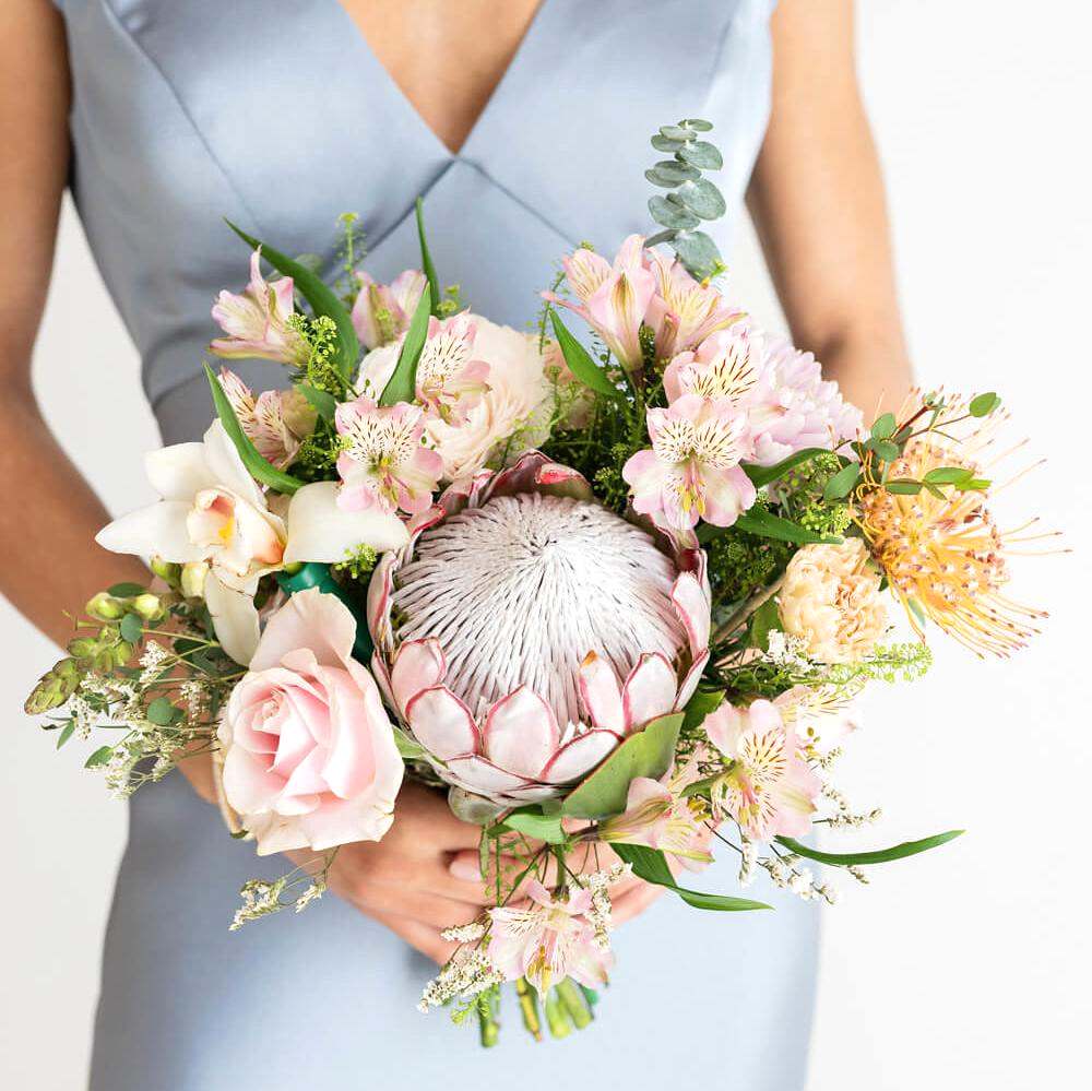 Elegant bridal bouquet of flowers held by a woman in a wedding dress