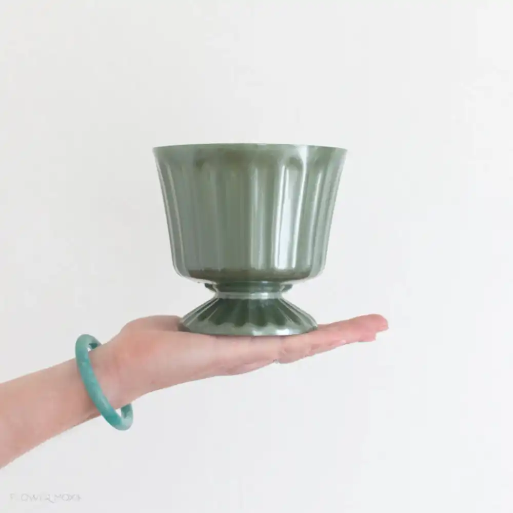 footed green plastic vase