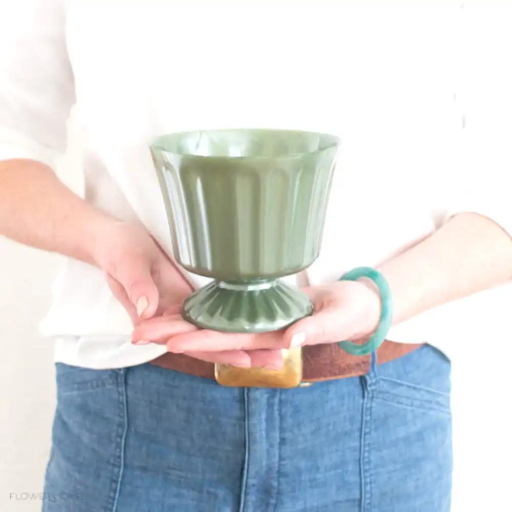 footed green plastic vase